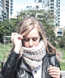 Mini bean stitch crochet cowl worn outdoors with black leather jacket