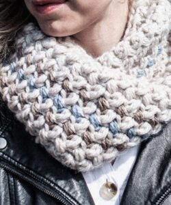Close up mini bean stitch crochet cowl worn outdoors with black leather jacket